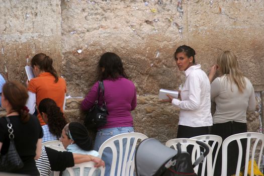 Jewish woman pray at the western wall October 03, 2006 in Jerusalem, IL. The wall is one of the holiest sites in Judaism attracting thousands of worshipers daily.