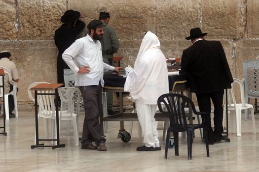 Jewish men pray at the western wall October 03, 2006 in Jerusalem, IL. The wall is one of the holiest sites in Judaism attracting thousands of worshipers daily.