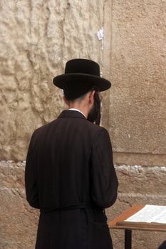 Jewish men pray at the western wall October 03, 2006 in Jerusalem, IL. The wall is one of the holiest sites in Judaism attracting thousands of worshipers daily.