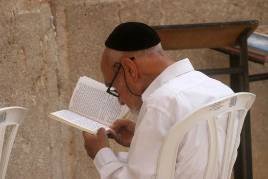 Jewish men pray at the western wall October 03, 2006 in Jerusalem, IL. The wall is one of the holiest sites in Judaism attracting thousands of worshipers daily.