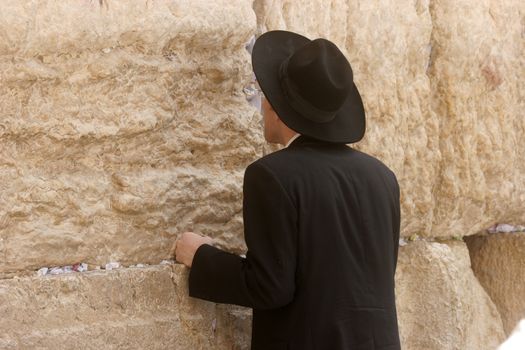 Jewish men pray at the western wall October 03, 2006 in Jerusalem, IL. The wall is one of the holiest sites in Judaism attracting thousands of worshipers daily.