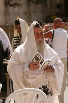 Jewish men pray at the western wall October 03, 2006 in Jerusalem, IL. The wall is one of the holiest sites in Judaism attracting thousands of worshipers daily.