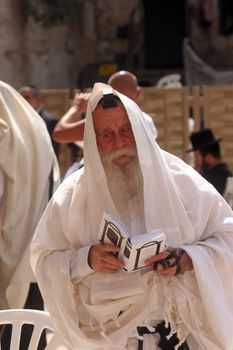 Jewish men pray at the western wall October 03, 2006 in Jerusalem, IL. The wall is one of the holiest sites in Judaism attracting thousands of worshipers daily.
