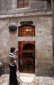 Via Dolorosa, 7th Stations of the Cross. The pilgrims who visit the Holy Land, pass the path that Jesus carried the cross to Calvary. Jerusalem on October 03, 2006.