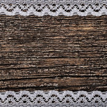 The openwork lace on a wooden background