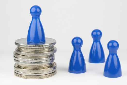 Conceptual financial position represented with colored play pieces and coins
