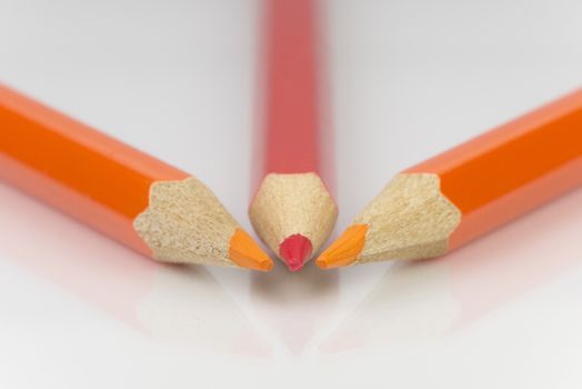 Abstract composition of a set wooden colour pencils against a white background
