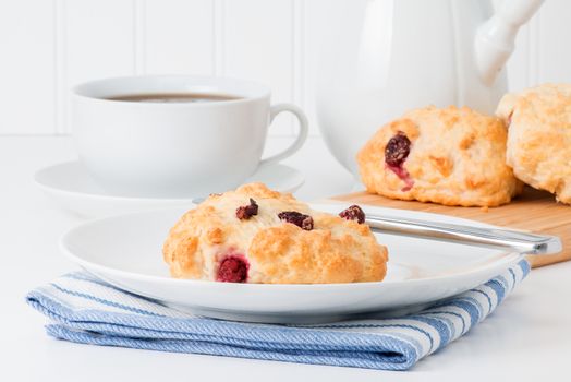 Fresh baked cranberry tea biscuits served with hot tea.