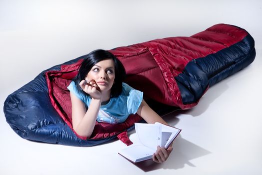 Young beutiful woman lying in the sleeping bag