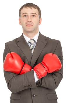 Businessman with crossed arms in red boxing gloves  isolated on white background
