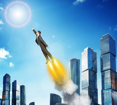 Businessman in suit flying above city, side view