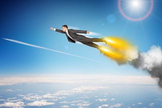 Businessman in suit flying above sky with clouds, side view