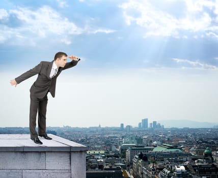 Businessman looking forward on building roof and cityscape background