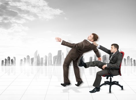 Businessman sitting on chair and kicking man on city background