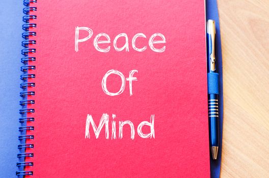 Peace of mind text concept write on notebook with pen