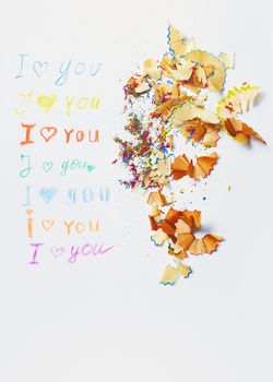 Paper with love you message and colored pencils trash