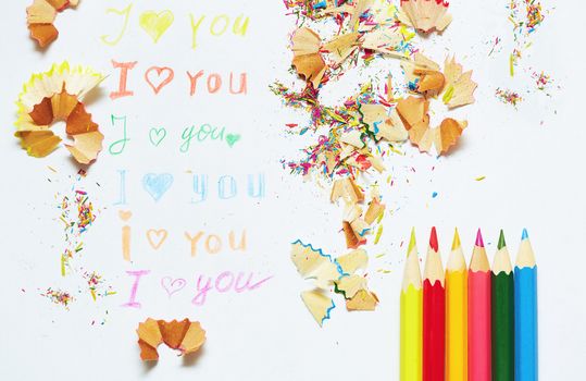 Paper with love you message and colored pencils trash