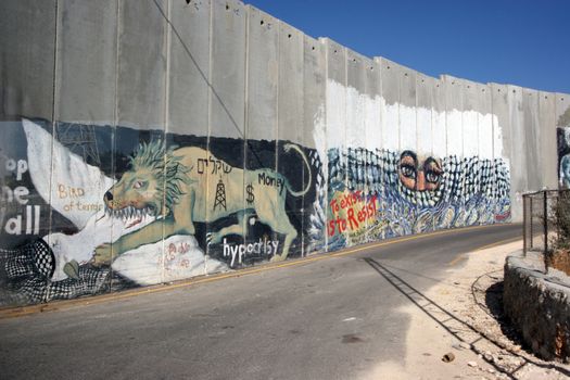 Activist graffiti adorns the Israeli separation wall in the West Bank town of Bethlehem on October 05, 2006.