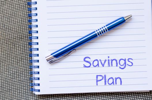 Savings plan text concept write on notebook with pen