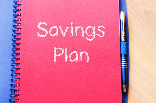 Savings plan text concept write on notebook with pen