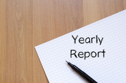 Yearly report text concept write on notebook with pen
