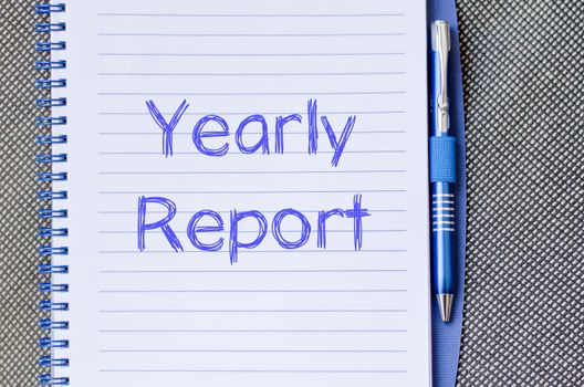 Yearly report text concept write on notebook with pen