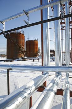 Tank storage crude Oil in winter landscape