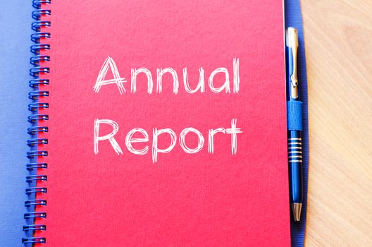 Annual report text concept write on notebook with pen