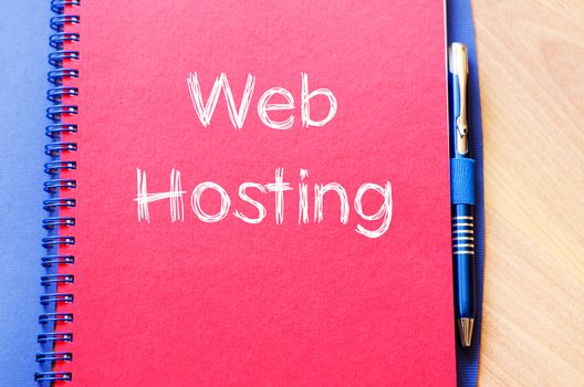 Web hosting text concept write on notebook with pen