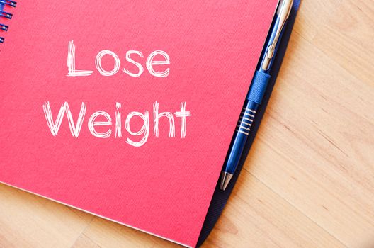 Lose weight text concept write on notebook with pen