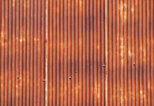 Old vintage bright rusty stained corroded metal goffered surface