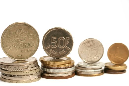 Coins of different currency on white background