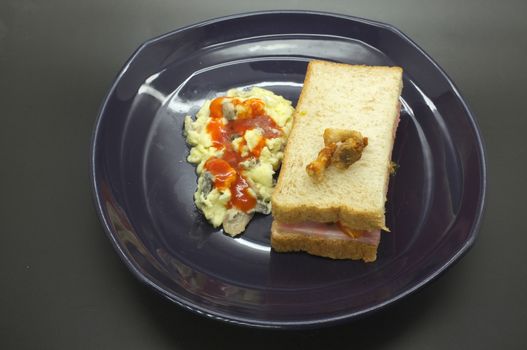 Ham and tomato sandwich with scrambled egg
