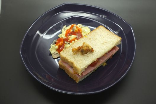 Ham and tomato sandwich with scrambled egg