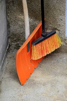 shovel and a grey and black orange broom