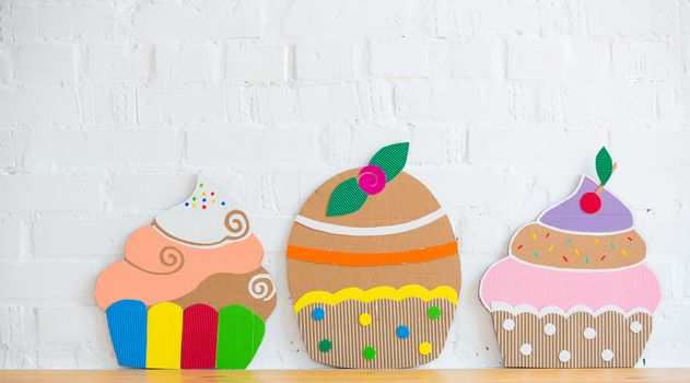 colored cakes handmade of cardboar on white background