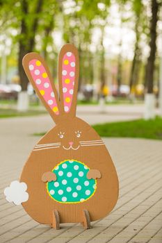 Decoration for Easter. Rabbit of cardboard in spring park