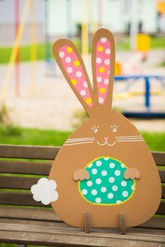 Decoration for Easter. Rabbit of cardboard in spring park