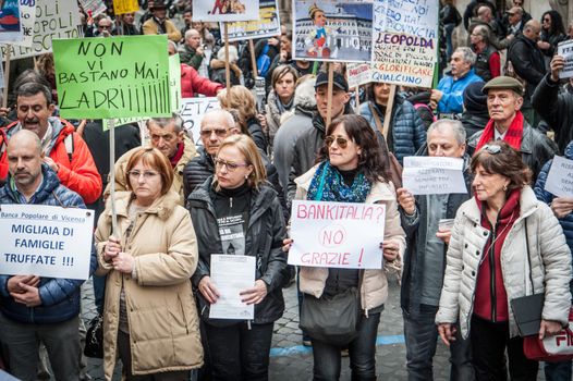 ITALY, Rome: As Italy's economy struggles in the face of a banking crisis, protesters fill the Piazza Santi Apostoli in Rome on January 31, 2016. They voice their fears about the state of their savings.Signs in the front read: (At left) Banca Popolare di Vicenza swindled thousands of families; and (at center) Bank of Italy? No thanks.