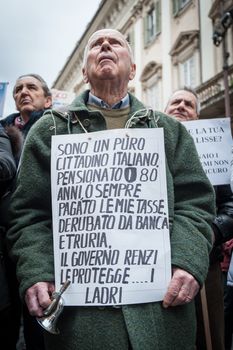 ITALY, Rome: As Italy's economy struggles in the face of a banking crisis, protesters fill the Piazza Santi Apostoli in Rome on January 31, 2016 as they voice their fears about the state of their savings. The man's sign says that he is in his 80s and retired, and refers to Prime Minister Matteo Renzi's administration as thieves.
