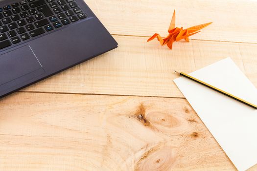 Collection of objects of an freelance worker or someone who works at home, on wooden background illuminated with natural light and photographed from above