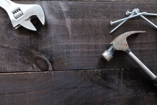 Still life containing several tools in dark wood background