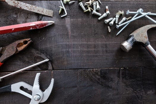 Still life containing several tools in dark wood background