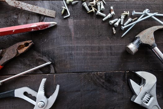 Still life containing several tools in dark wood background