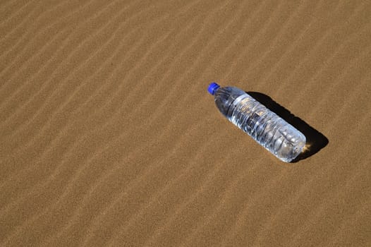 Bottle of water in Sahara