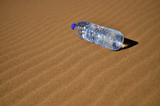 Bottle of water in Sahara