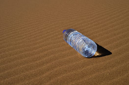 Bottle of water in Sahara