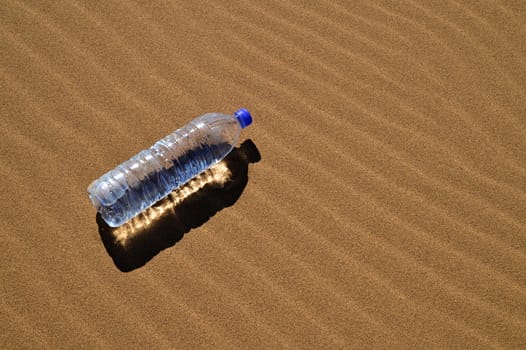 Bottle of water in Sahara