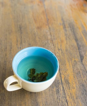 Cup of hot green tea  on wood table