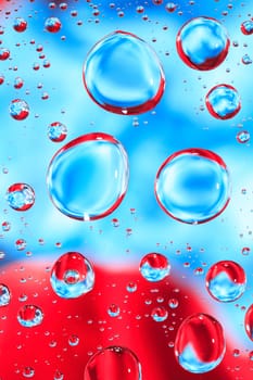 Abstract red and blue background with various water drops
